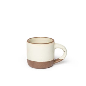 Ceramic mug with a two-tone design on a white background